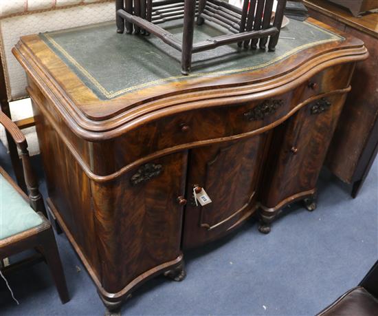 A 19th century Continental mahogany writing desk of serpentine form W.109cm